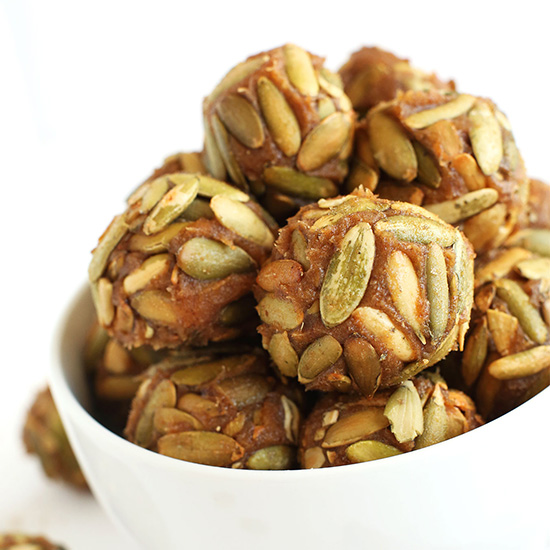 Bowl of Vegan Pumpkin Caramels rolled in pumpkin seeds