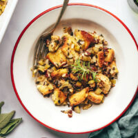 Plate of vegan gluten-free stuffing topped with fresh rosemary