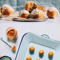 Placing a Vegan Golden Milk Snack Bite onto a tray with the rest of the batch